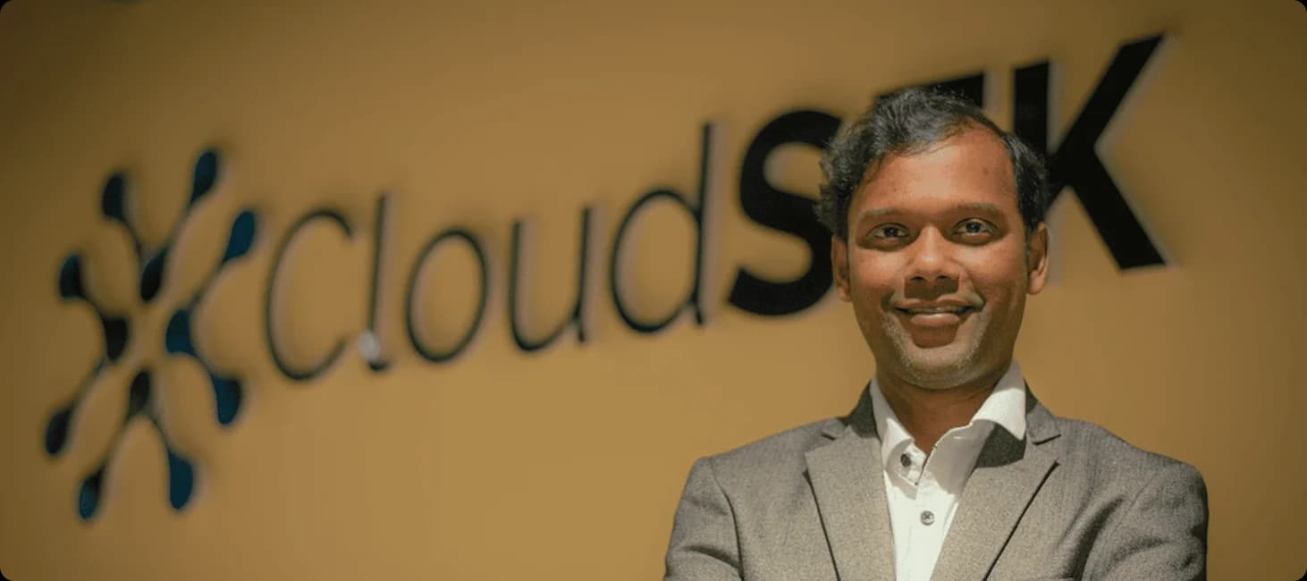 Rahul Sasi, CloudSEK founder, in front of CloudSEK office sign