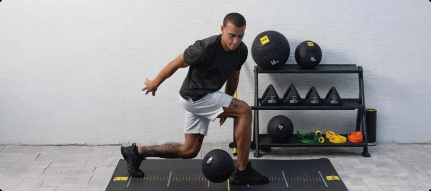 Athlete training with TRX fitness equipment